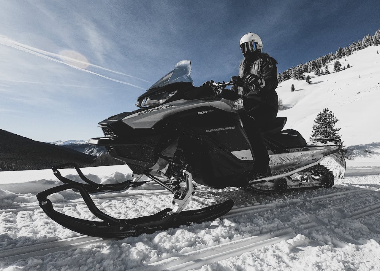 An adventurous snowmobile ride in the snowy Colorado mountains on a clear winter day.